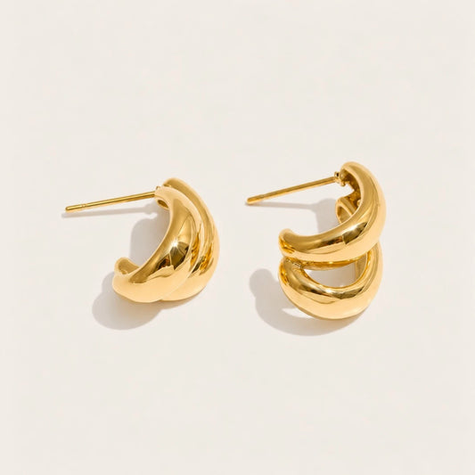Gold Doppia EARRINGS: a pair of hoops formed by two smooth C-shaped curves layered together — Folie à Trois