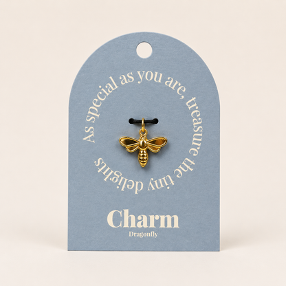 The Dragonfly CHARM displayed on a dusty blue Charm gift tag, hanging from a black cord against the card text As special as you are.