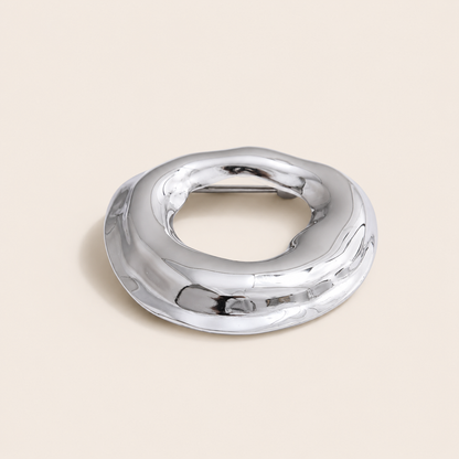 Silver molten organic-shaped ring brooch, small size, on a cream backdrop — Folie à Trois Duna BROOCH