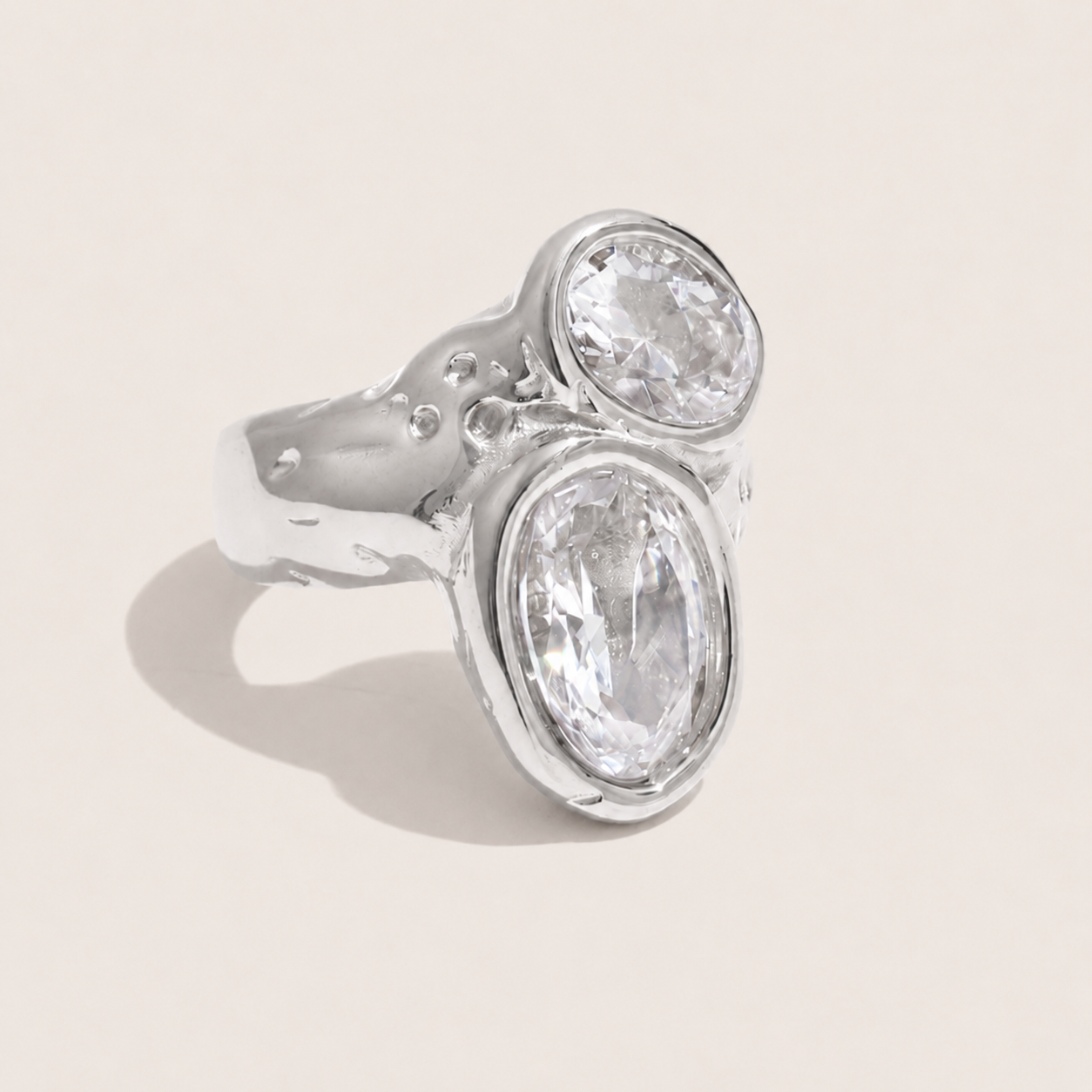 Silver ring with two bezel-set oval white zirconia stones on a hammered, organic-texture band — Folie à Trois Dune Twist RING