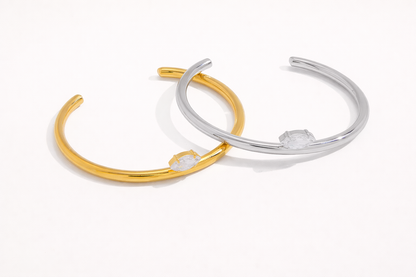 Electric Frost BRACELET pair in gold and silver, open cuffs crossed together, each set with a marquise crystal.