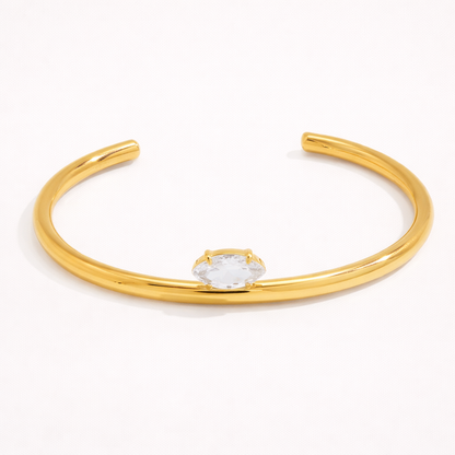 Electric Frost BRACELET in gold, a slim open cuff with a single marquise crystal, shown alone on white.