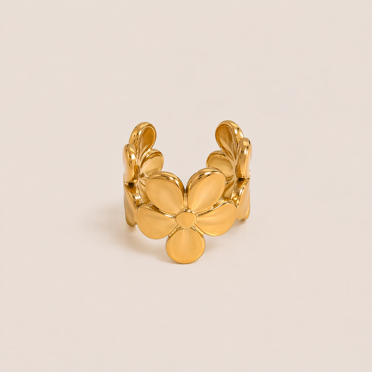 The Esme EAR CUFF is a gold open ear cuff shaped like a layered flower with soft, sculpted petals for a delicate statement look.