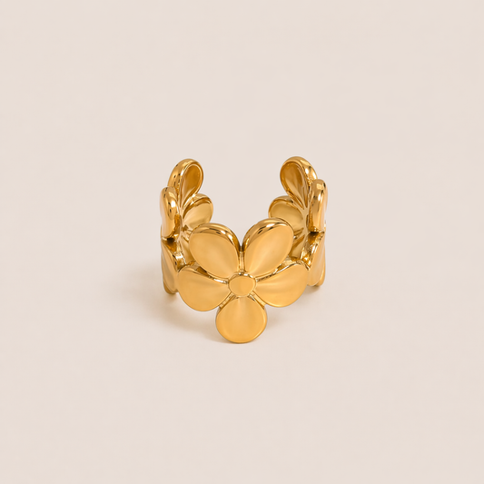 The Esme EAR CUFF is a gold open ear cuff shaped like a layered flower with soft, sculpted petals for a delicate statement look.