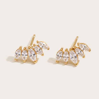 Gold marquise-cut zirconia climber studs fanned in a cluster on a cream backdrop — Folie à Trois Facet EARRINGS wholesale jewelry