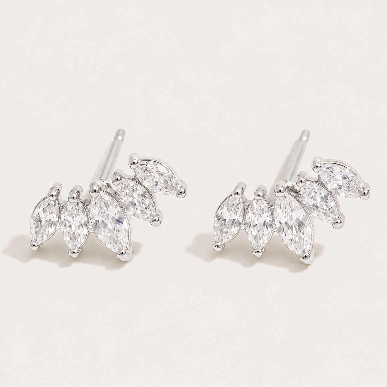 Silver-tone marquise-cut zirconia climber studs fanned in a cluster on a cream backdrop — Folie à Trois Facet EARRINGS wholesale jewelry