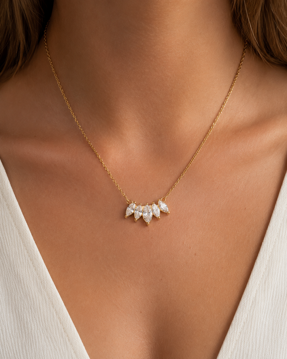 Gold Facet NECKLACE with marquise zirconia pendant worn close on the neckline over a white top — Folie à Trois wholesale jewelry
