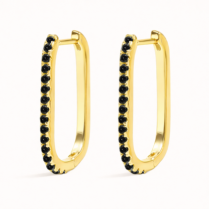 In this colorway, Fair Game Earrings pair a gold oblong hoop with a striking row of jet-black pave stones along one side.