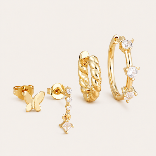 Four-piece Fairfax SET gold earrings: a butterfly stud, a cubic zirconia drop stud, a twisted rope hoop, and a hoop with three round stones.