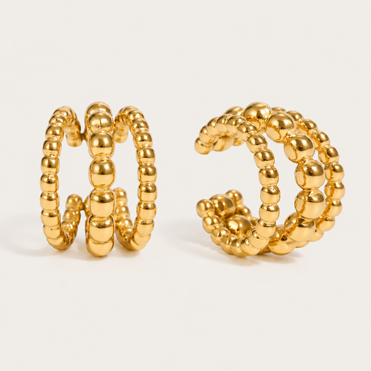 Pair of gold beaded ear cuffs with a double row of graduated balls, product shot for the Folie à Trois Felix EAR CUFF.