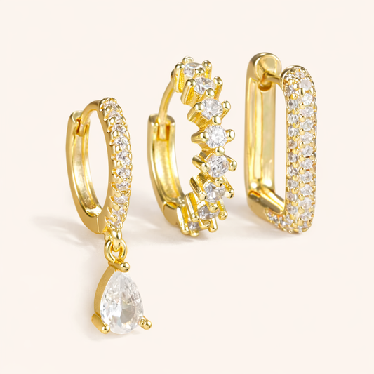 The Fia SET includes three gold pieces: a pave huggie with teardrop drop, a zigzag huggie, and a pave rectangle hoop.