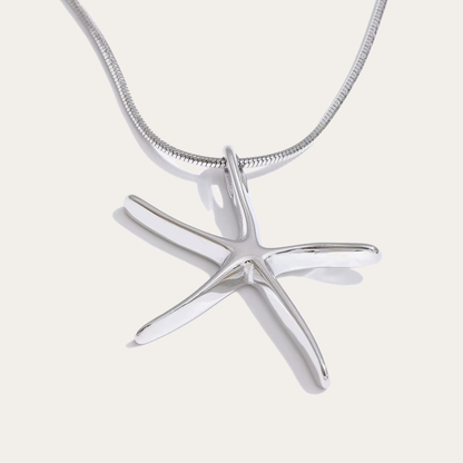 The Fiji NECKLACE in silver, its sculptural starfish pendant shown alone on a fine snake chain against a plain studio background.