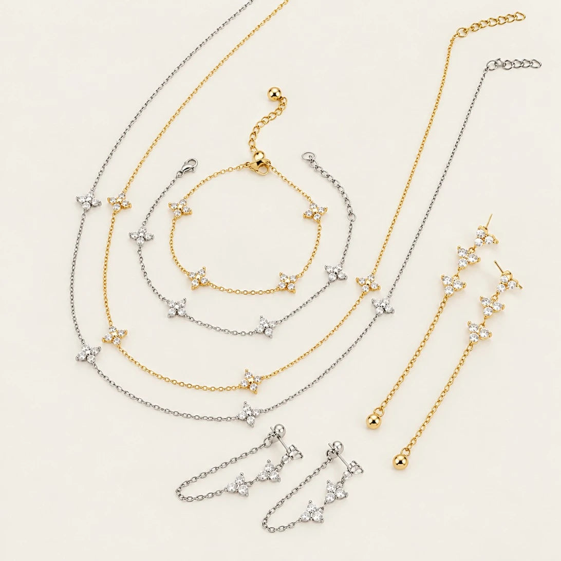 Fiore collection flat lay: gold and silver-tone flower bracelets, necklaces and chain earrings — Folie à Trois wholesale