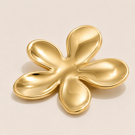 Gold five-petal flower brooch with a glossy sculptural finish on a cream backdrop — Folie à Trois Flora BROOCH