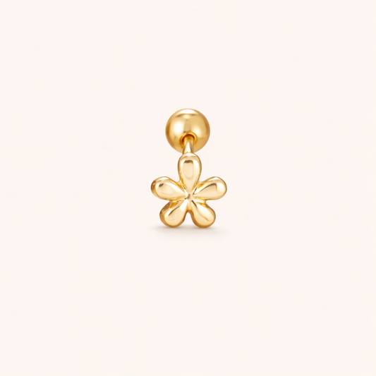 The Flower PIERCING is a gold labret stud topped with a small polished five-petal flower charm design.