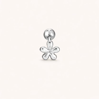 The Flower PIERCING is shown in silver, a labret stud topped with a small five-petal flower charm design.