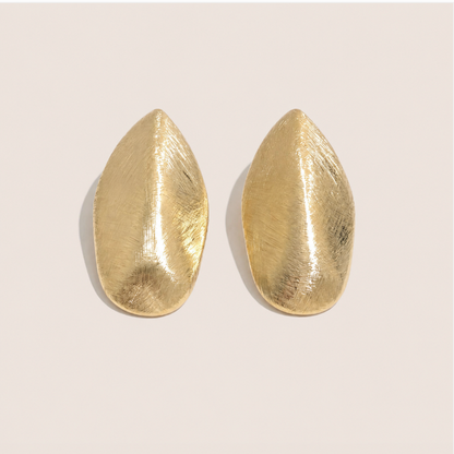 Gold leaf-shaped stud earrings with a brushed textured finish on a cream backdrop — Folie à Trois Foglia EARRINGS