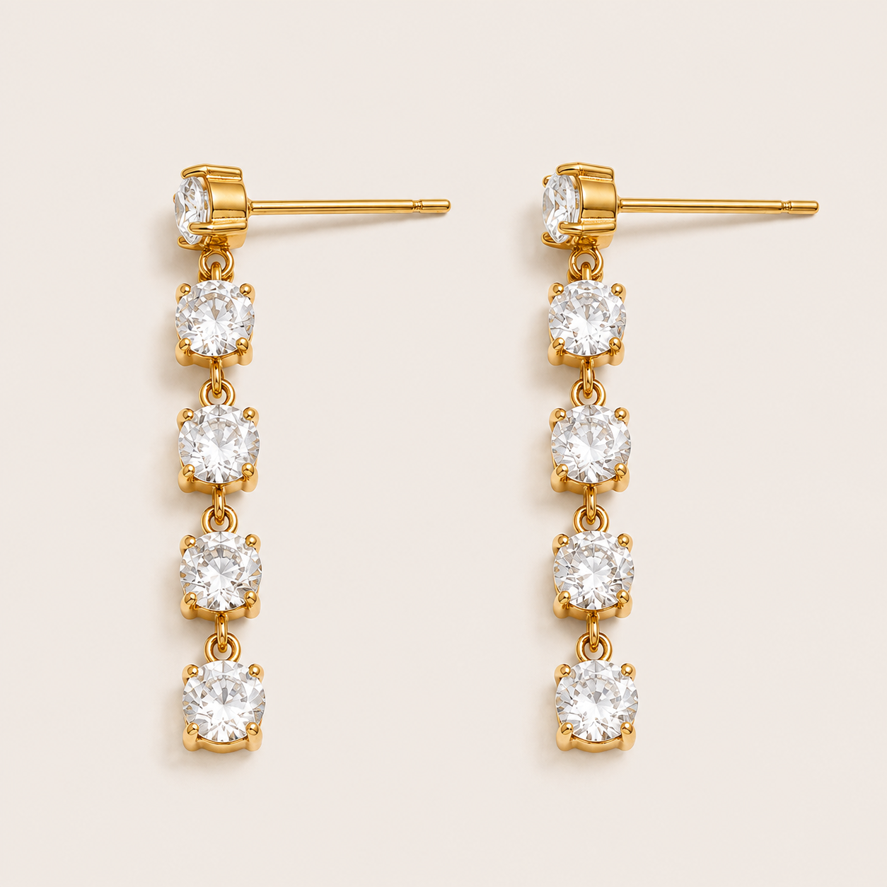 Gold drop earring with four graduated round white zirconia stones cascading down a chain — Folie à Trois Fringe EARRINGS.