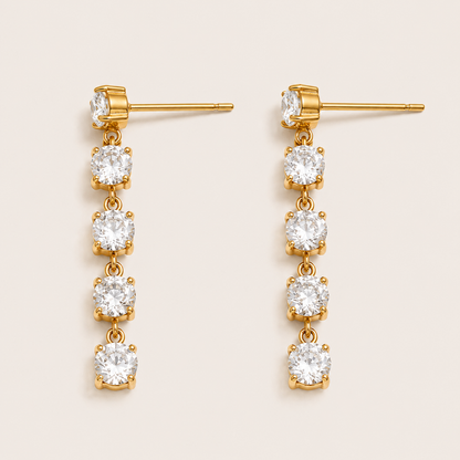 Gold drop earring with four graduated round white zirconia stones cascading down a chain — Folie à Trois Fringe EARRINGS.