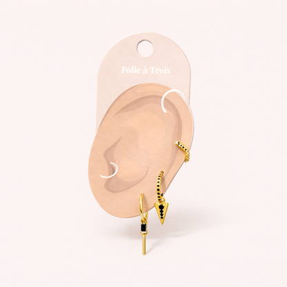 The Gabriella SET in gold with black onyx displayed on a branded Folie à Trois ear card with the stud, triangle hoop, and bar-dangle hoop.