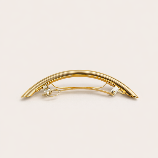 Gia HAIR CLIP curved gold-tone metal barrette with ridged texture, studio shot.