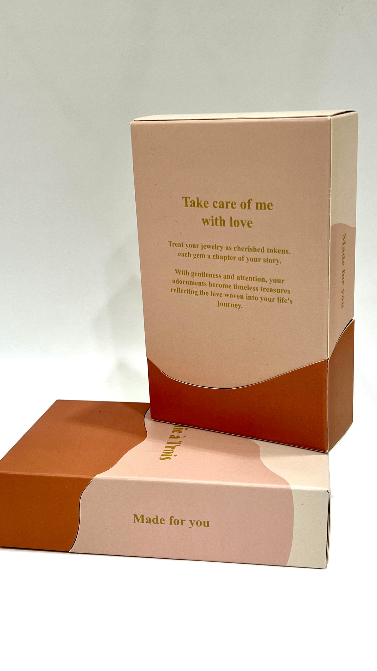 Open Folie à Trois gift box showing its take care of me with love message stacked on a closed matching box.