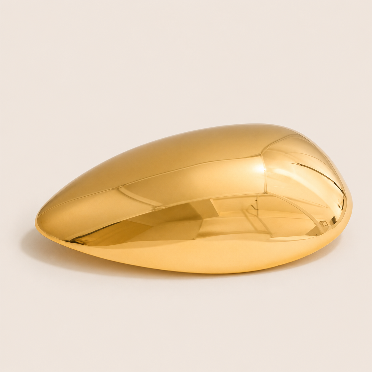 Gold teardrop-shaped sculptural brooch with a smooth domed surface on a cream backdrop — Folie à Trois Gota BROOCH