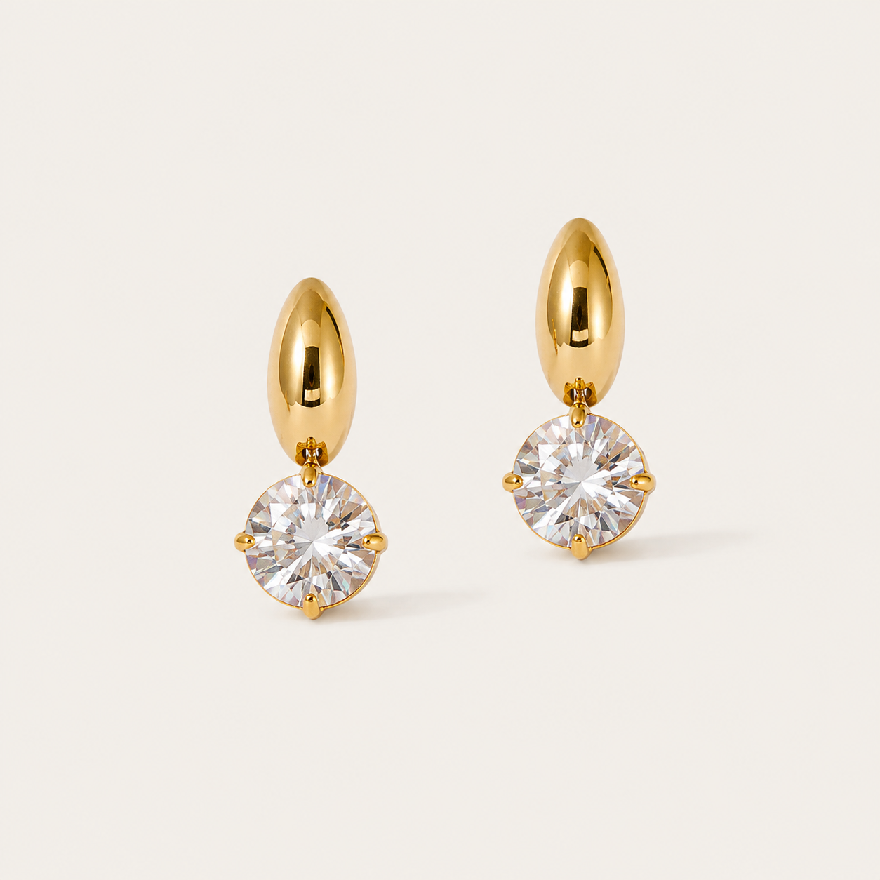 Gold stud earrings with a domed bean top and a round white zirconia drop on a cream backdrop — Folie à Trois Halcyon EARRINGS