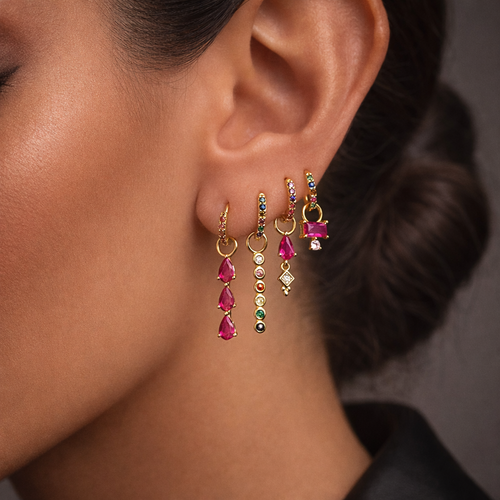 Harper Set worn close on the ear alongside a layered necklace, gold huggies with ruby gemstone drop charms.