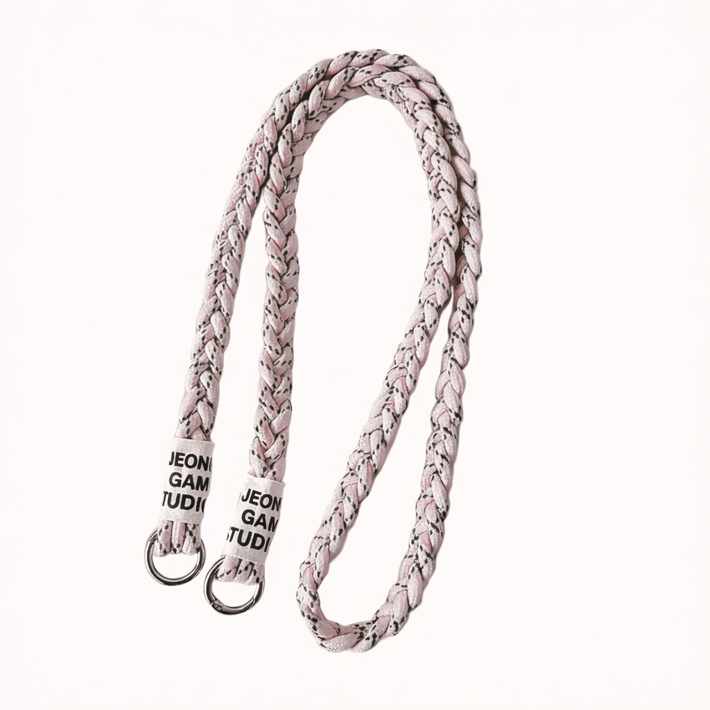 Blush pink braided cord Havana long phone strap with fleck detailing, coiled with silver ring hardware.