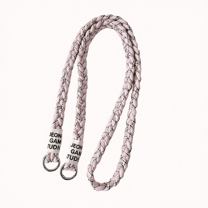 Blush pink braided cord Havana long phone strap with fleck detailing, coiled with silver ring hardware.