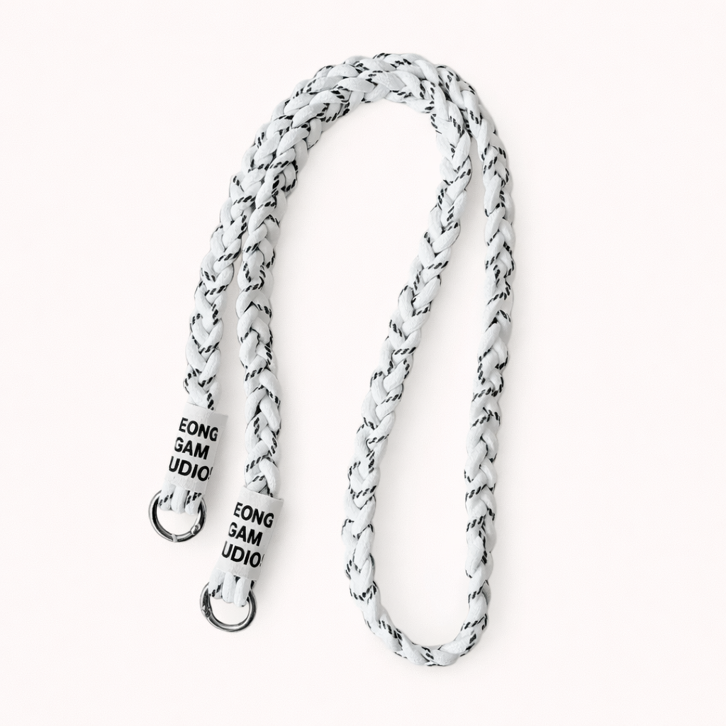 White braided cord Havana long phone strap with fleck detailing, coiled with silver ring hardware.
