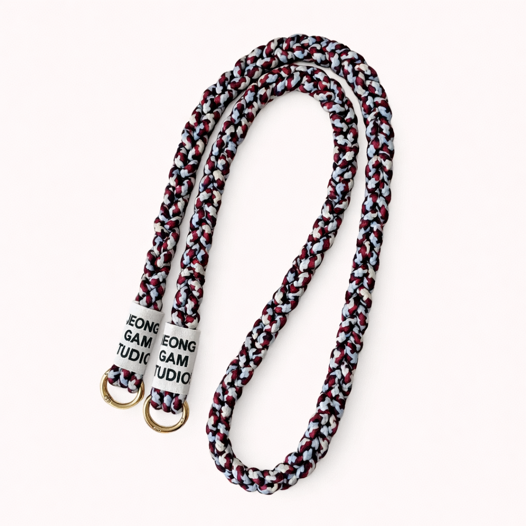 Maroon, navy, and gray braided cord Havana long phone strap, coiled with gold ring hardware.
