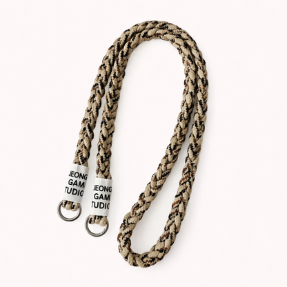 Beige and brown camo-print braided cord Havana long phone strap, coiled with silver ring hardware.
