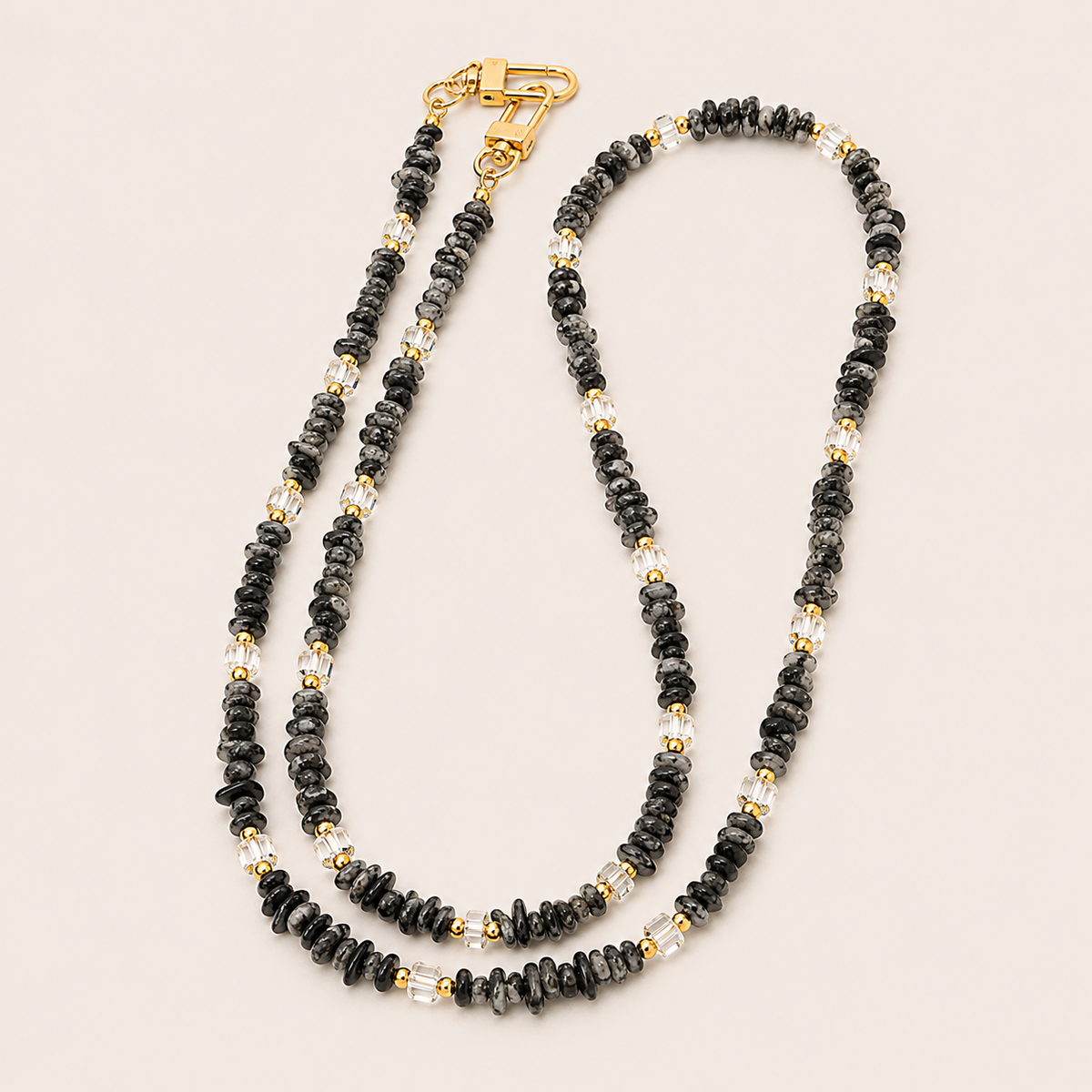Double-strand black speckled and crystal bead phone chain with gold accents on cream — Folie à Trois Hollis wholesale phone chain