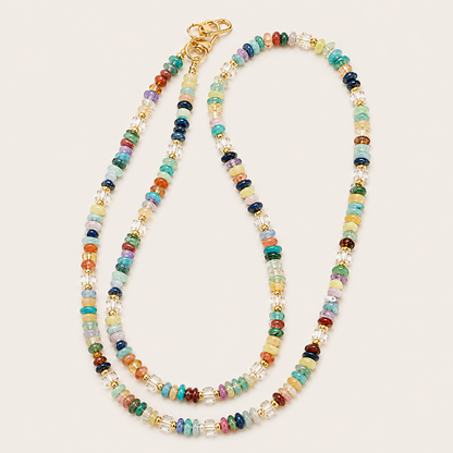 Multicolor gemstone rondelle phone chain with gold clasps laid flat on cream — Folie à Trois Hollis wholesale phone chain