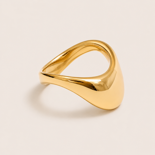 Gold dome ring with a smooth teardrop-shaped face tapering into a slim curved band — Folie à Trois Honey Drip RING.