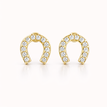 The Horseshoe EARRINGS are gold studs shaped like horseshoes, fully lined with sparkling round crystals.