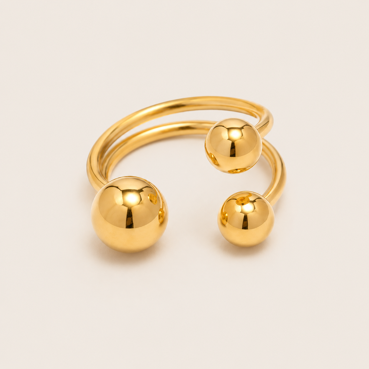 Gold open ring with a spiral double band accented by three graduated polished ball details — Folie à Trois Ibiza RING.