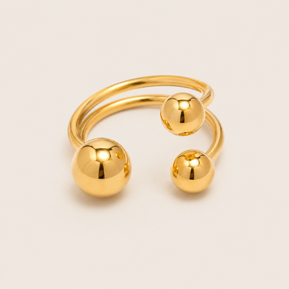 Gold open ring with a spiral double band accented by three graduated polished ball details — Folie à Trois Ibiza RING.
