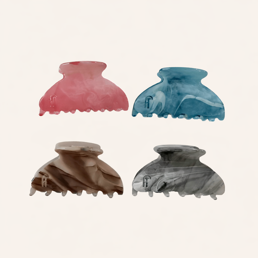 Four Ice Queen HAIR CLIP marbled claw clips in pink, blue, brown and grey, arranged in a grid on a cream studio background.