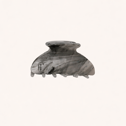 Grey and charcoal marbled acetate claw clip from the Ice Queen HAIR CLIP collection, shown on a cream studio background.