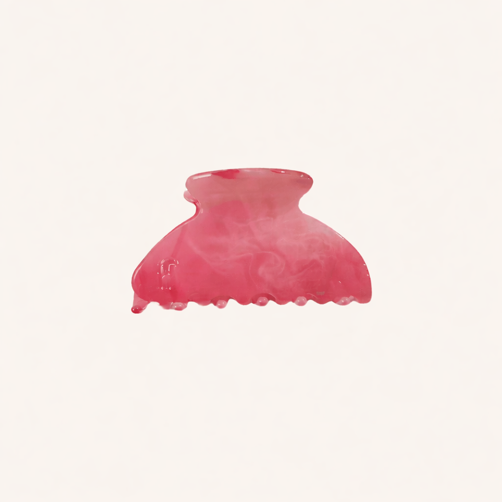 Pink marbled acetate claw clip from the Ice Queen HAIR CLIP collection, shown on a cream studio background.