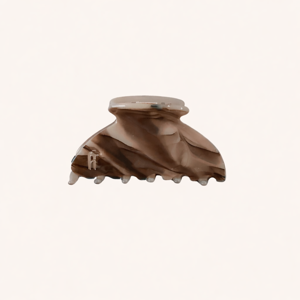 Brown and taupe marbled acetate claw clip from the Ice Queen HAIR CLIP collection, shown on a cream studio background.