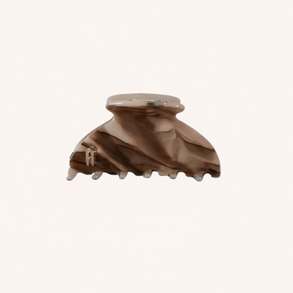 Brown and taupe marbled acetate claw clip from the Ice Queen HAIR CLIP collection, shown on a cream studio background.