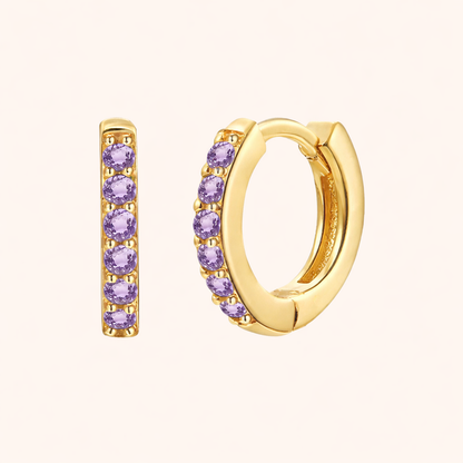 In a Dream Earrings in gold with lilac-purple crystals, the huggie hoop set with six round graduated stones.