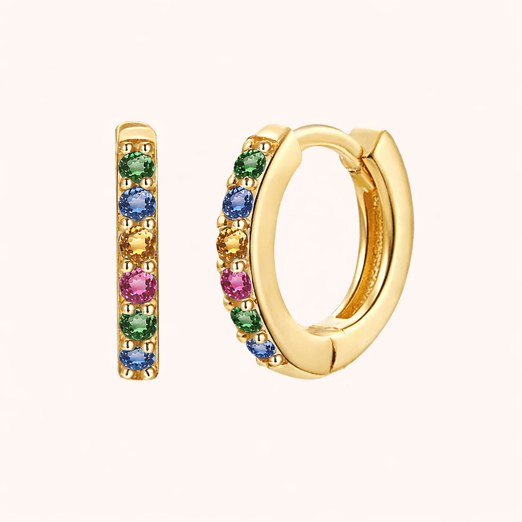 In a Dream Earrings in gold with rainbow multicolor crystals, the huggie hoop alternating green, blue, yellow, and pink stones.
