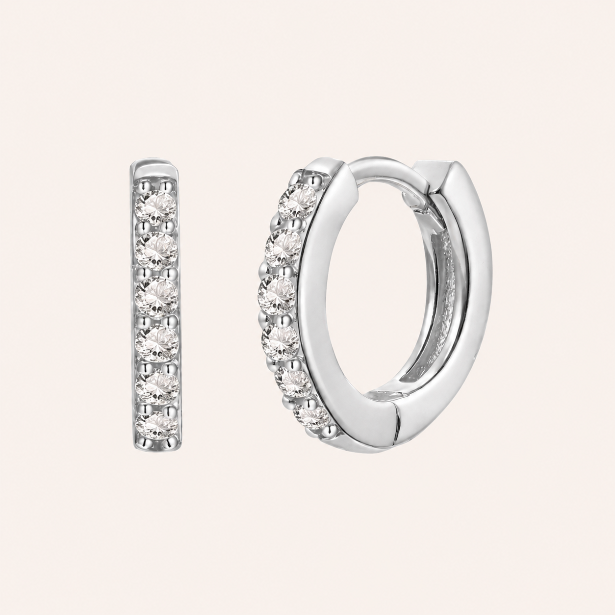 In a Dream Earrings in silver with clear crystals, the huggie hoop set with six round graduated stones.