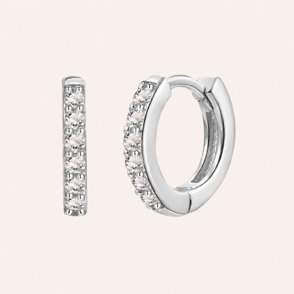 In a Dream Earrings in silver with clear crystals, the huggie hoop set with six round graduated stones.