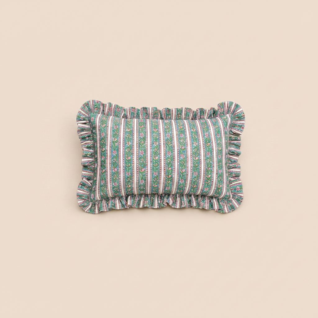 Indigo Mist Rectangle cushion in green vertical stripes with a delicate floral vine print and a ruffled trim on a warm cream background.